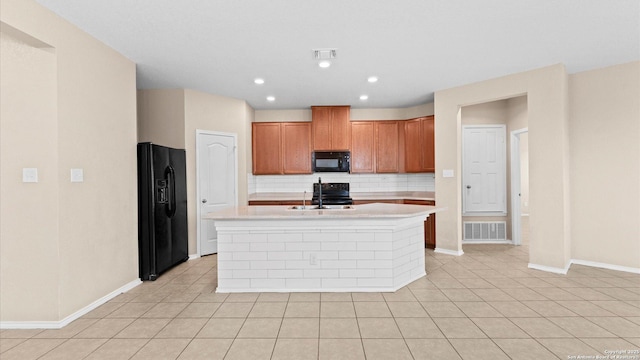 4527 Southton Way, San Antonio, TX 78223 - kitchen with black appliances, backsplash, light countertops, baseboards, and a kitchen island with sink