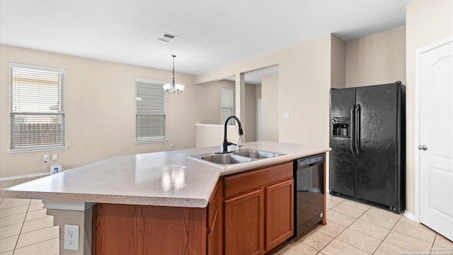 4527 Southton Way, San Antonio, TX 78223 - kitchen with black appliances, a sink, brown cabinetry, light tile patterned floors, and a chandelier