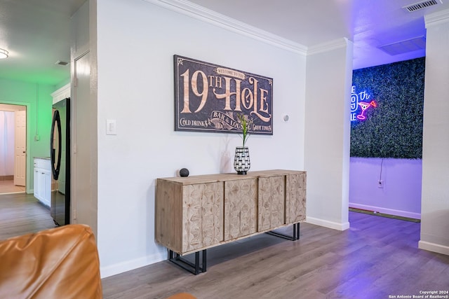 555 Hansford, San Antonio, TX 78210 - detailed view of freestanding refrigerator, wood finished floors, crown molding, and baseboards
