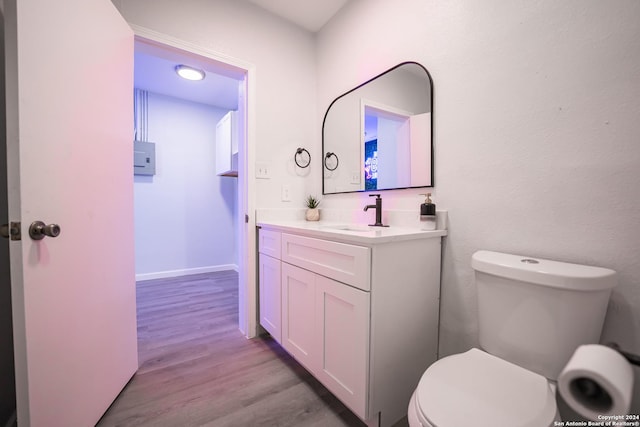 555 Hansford, San Antonio, TX 78210 - half bath featuring vanity, toilet, and wood finished floors