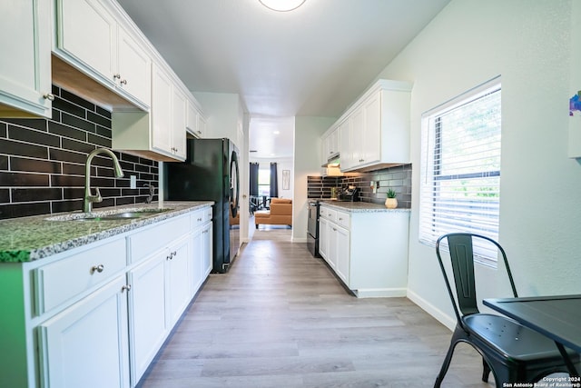 555 Hansford, San Antonio, TX 78210 - kitchen with a sink, decorative backsplash, healthy amount of natural light, and stainless steel electric range oven