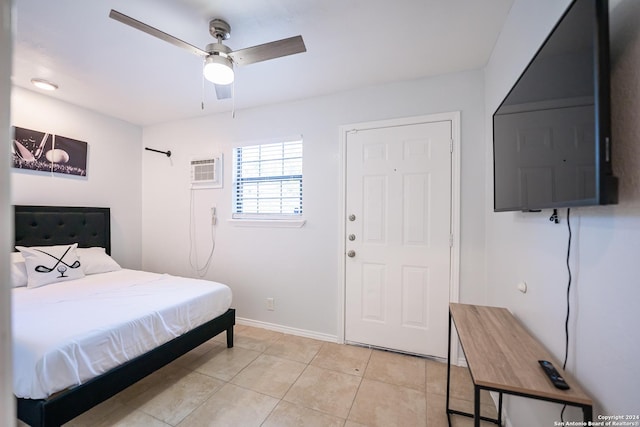 555 Hansford, San Antonio, TX 78210 - bedroom featuring an AC wall unit, light tile patterned flooring, and baseboards