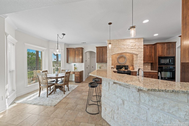 154 Lake View Dr, Boerne, TX 78006 - kitchen featuring black appliances, crown molding, arched walkways, light stone countertops, and baseboards