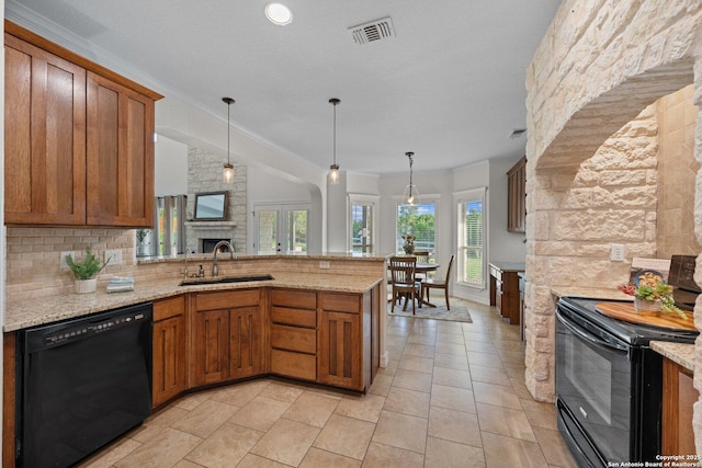 154 Lake View Dr, Boerne, TX 78006 - kitchen with black appliances, a sink, brown cabinets, a peninsula, and ornamental molding