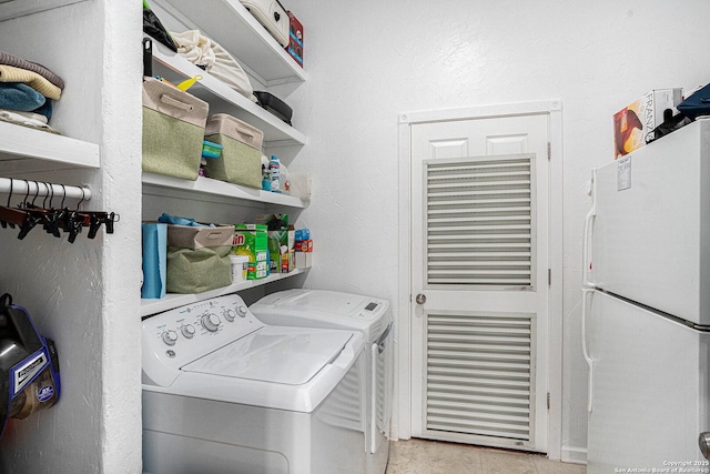 177 Ten W Dr, Comfort, TX 78013 - laundry area with washer and clothes dryer and light tile patterned floors