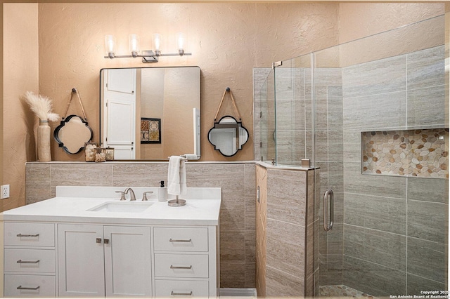 177 Ten W Dr, Comfort, TX 78013 - bathroom featuring vanity, a shower stall, tile walls, and a textured wall