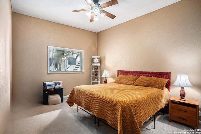 177 Ten W Dr, Comfort, TX 78013 - bedroom with carpet floors, a textured wall, a ceiling fan, and baseboards