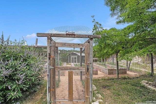 177 Ten W Dr, Comfort, TX 78013 - view of yard featuring a vegetable garden, an outbuilding, and exterior structure