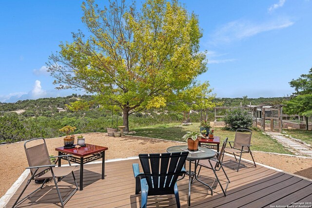 177 Ten W Dr, Comfort, TX 78013 - deck with outdoor dining area and a lawn