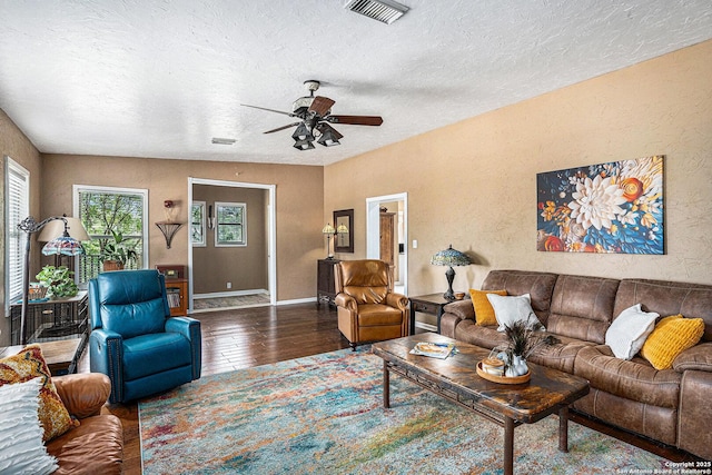 177 Ten W Dr, Comfort, TX 78013 - living area with wood finished floors, healthy amount of natural light, a textured ceiling, a ceiling fan, and baseboards