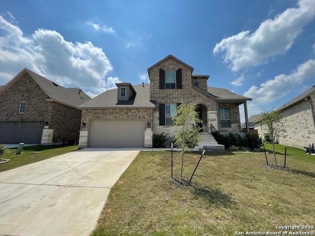 12023 Horseshoe, San Antonio, TX 78254 - view of front facade featuring a front yard, a garage, concrete driveway, brick siding, and covered porch