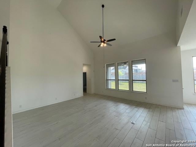12023 Horseshoe, San Antonio, TX 78254 - empty room featuring ceiling fan, light wood-style flooring, high vaulted ceiling, and baseboards