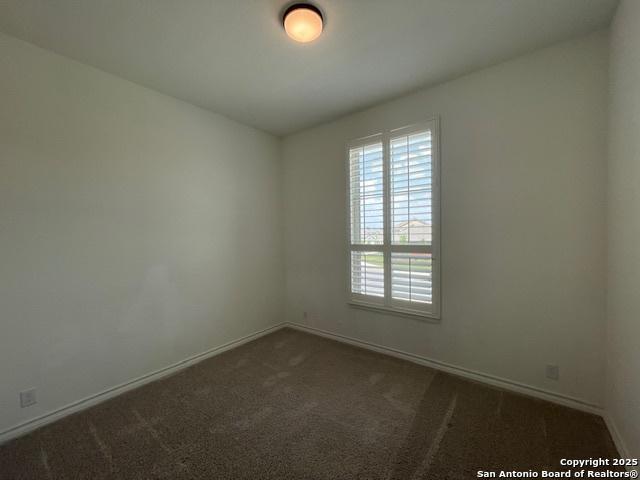12023 Horseshoe, San Antonio, TX 78254 - empty room featuring baseboards and dark carpet