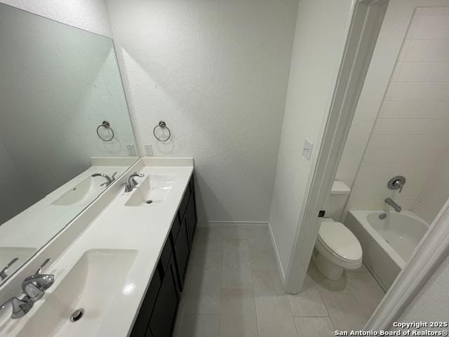 12023 Horseshoe, San Antonio, TX 78254 - full bathroom featuring double vanity, toilet, tile patterned floors, baseboards, and washtub / shower combination