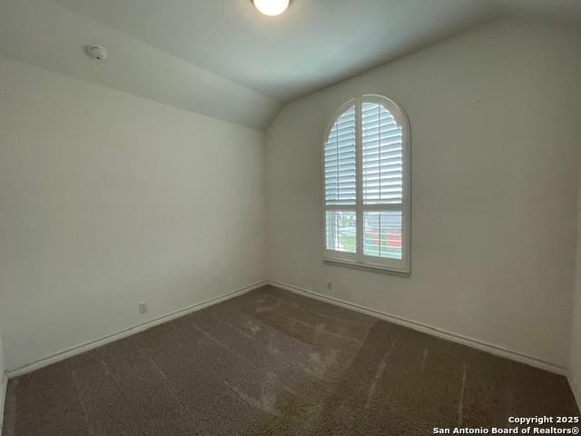 12023 Horseshoe, San Antonio, TX 78254 - empty room featuring lofted ceiling, dark carpet, a smoke detector, and baseboards