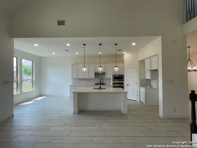 12023 Horseshoe, San Antonio, TX 78254 - kitchen featuring a sink, tasteful backsplash, white cabinetry, light countertops, and recessed lighting