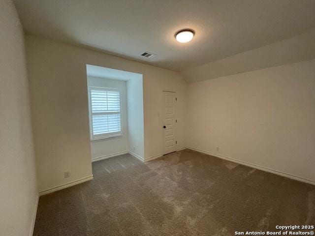 12023 Horseshoe, San Antonio, TX 78254 - unfurnished room featuring dark colored carpet, baseboards, and lofted ceiling