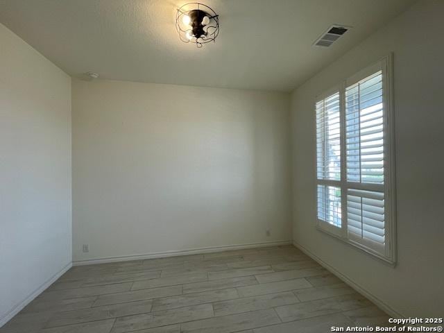 12023 Horseshoe, San Antonio, TX 78254 - empty room with plenty of natural light, baseboards, and light wood-style floors