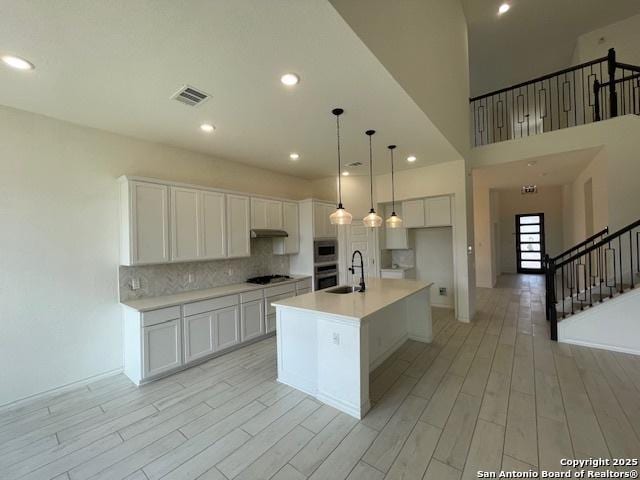 12023 Horseshoe, San Antonio, TX 78254 - kitchen with a sink, white cabinetry, backsplash, light countertops, and recessed lighting