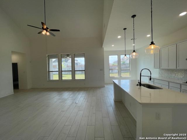 12023 Horseshoe, San Antonio, TX 78254 - kitchen with a sink, open floor plan, recessed lighting, white cabinetry, and ceiling fan