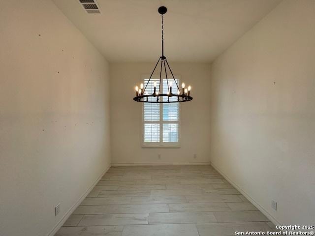 12023 Horseshoe, San Antonio, TX 78254 - unfurnished room with a chandelier, baseboards, and light wood-style floors