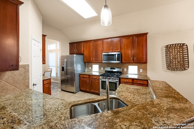 21931 Ruby Run, San Antonio, TX 78259 - kitchen with stainless steel appliances, lofted ceiling, pendant lighting, light tile patterned floors, and tasteful backsplash