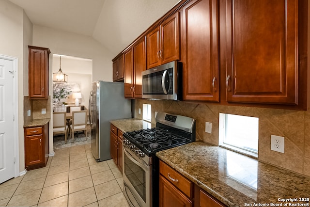 21931 Ruby Run, San Antonio, TX 78259 - kitchen featuring appliances with stainless steel finishes, tasteful backsplash, light tile patterned flooring, dark stone counters, and lofted ceiling