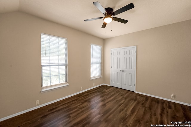 21931 Ruby Run, San Antonio, TX 78259 - unfurnished bedroom with dark wood-type flooring, baseboards, a closet, and vaulted ceiling