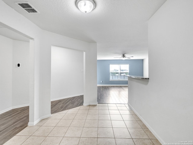7071 Capeshaw, San Antonio, TX 78252 - spare room featuring ceiling fan, a textured ceiling, light wood-type flooring, and baseboards