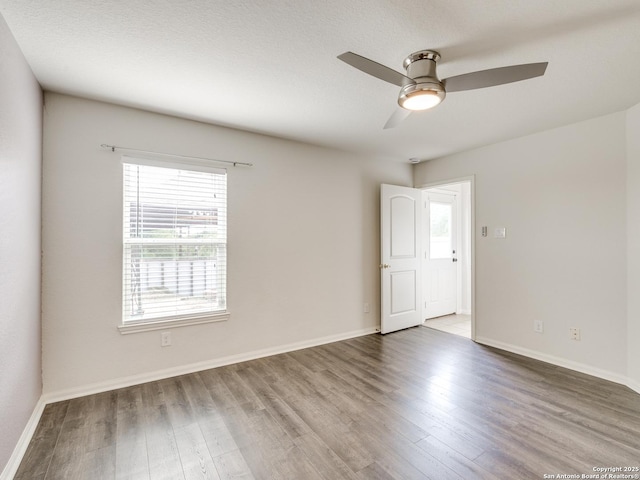 7071 Capeshaw, San Antonio, TX 78252 - spare room with wood finished floors, ceiling fan, and baseboards