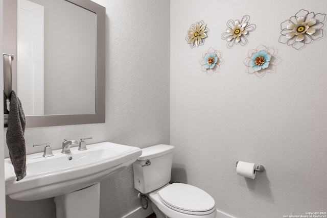 17918 Cantera Ct, San Antonio, TX 78255 - bathroom featuring toilet, a sink, and a textured wall