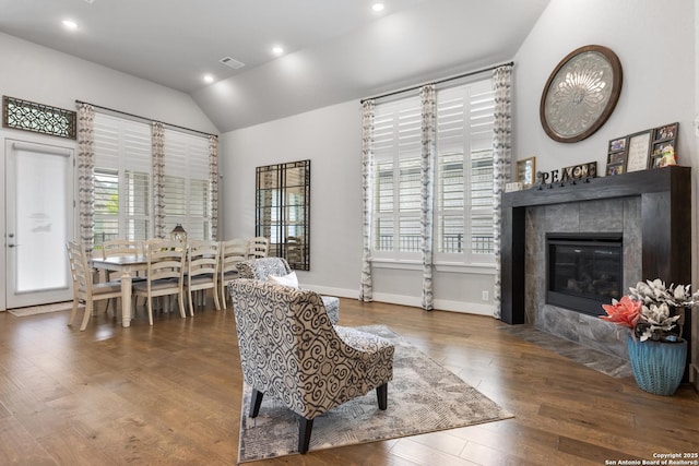 17918 Cantera Ct, San Antonio, TX 78255 - living area featuring healthy amount of natural light, a tiled fireplace, lofted ceiling, wood finished floors, and recessed lighting