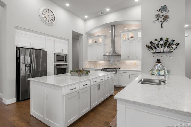 17918 Cantera Ct, San Antonio, TX 78255 - kitchen featuring stainless steel appliances, wall chimney exhaust hood, a sink, light stone counters, and backsplash