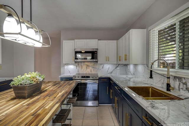 1632 Dogwood Ln, Schertz, TX 78154 - kitchen featuring appliances with stainless steel finishes, a sink, white cabinets, and decorative backsplash