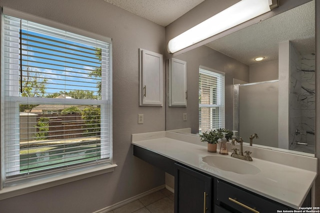 1632 Dogwood Ln, Schertz, TX 78154 - full bathroom featuring a textured ceiling, tile patterned flooring, a shower stall, plenty of natural light, and vanity