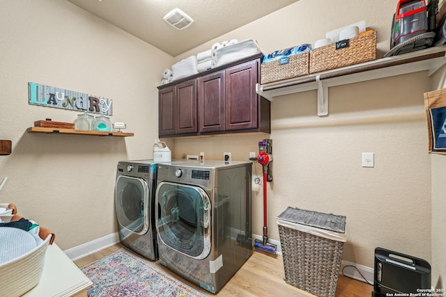 17055 Sonoma, San Antonio, TX 78255 - washroom with washing machine and clothes dryer, light wood finished floors, cabinet space, and baseboards