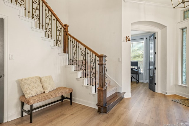 17055 Sonoma, San Antonio, TX 78255 - foyer with arched walkways, light wood finished floors, baseboards, ornamental molding, and stairs