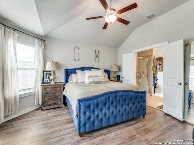 1136 Amber Lk, Seguin, TX 78155 - bedroom featuring vaulted ceiling, wood finished floors, ceiling fan, and connected bathroom