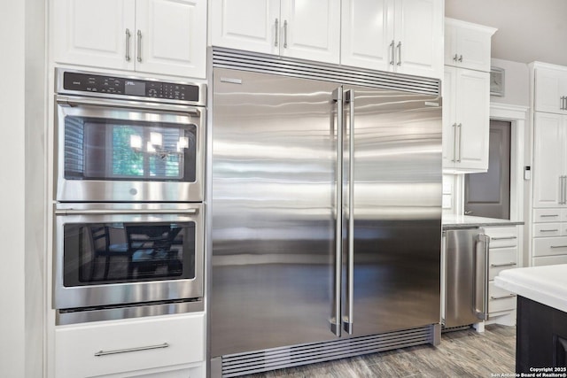 2834 Olive Ave, Schertz, TX 78154 - kitchen with appliances with stainless steel finishes, white cabinetry, and wood finished floors