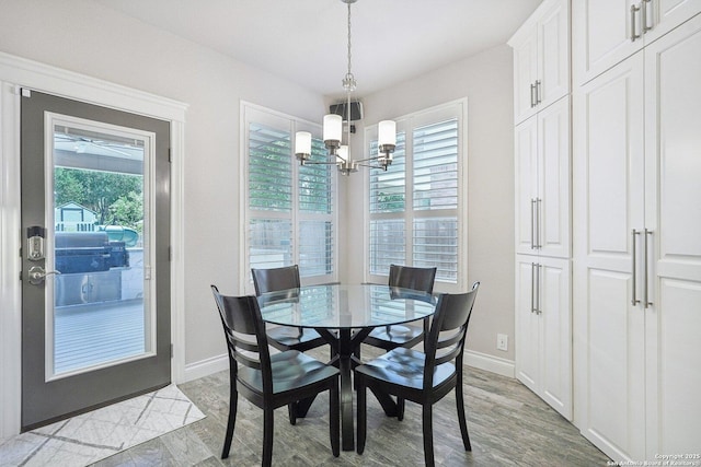 2834 Olive Ave, Schertz, TX 78154 - dining room with a chandelier, plenty of natural light, baseboards, and light wood-type flooring