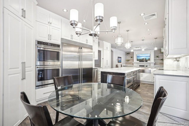 2834 Olive Ave, Schertz, TX 78154 - dining area featuring dark wood finished floors, recessed lighting, and a chandelier