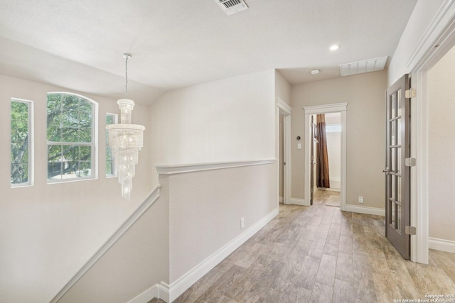 2834 Olive Ave, Schertz, TX 78154 - corridor featuring light wood-type flooring, baseboards, an upstairs landing, and a chandelier