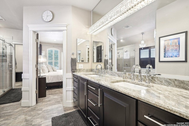 2834 Olive Ave, Schertz, TX 78154 - ensuite bathroom featuring double vanity, a stall shower, and wood finished floors