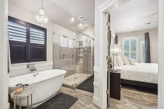 2834 Olive Ave, Schertz, TX 78154 - bathroom with a freestanding bath, a shower stall, recessed lighting, a chandelier, and connected bathroom