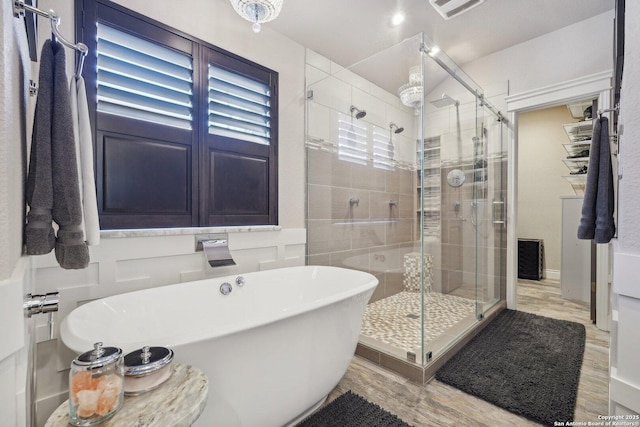 2834 Olive Ave, Schertz, TX 78154 - bathroom featuring a soaking tub, a shower stall, and wood finished floors
