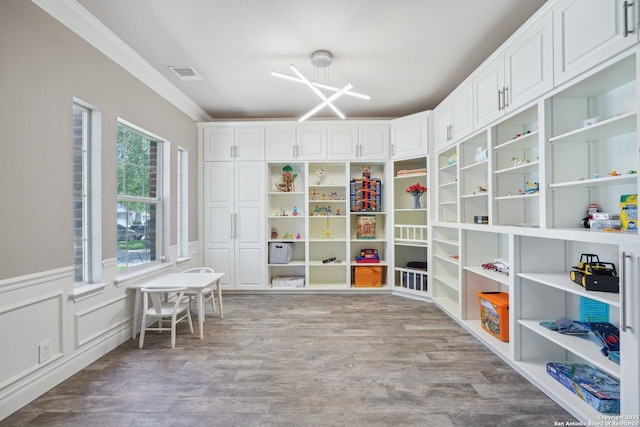 2834 Olive Ave, Schertz, TX 78154 - playroom featuring ornamental molding, light wood-type flooring, and wainscoting