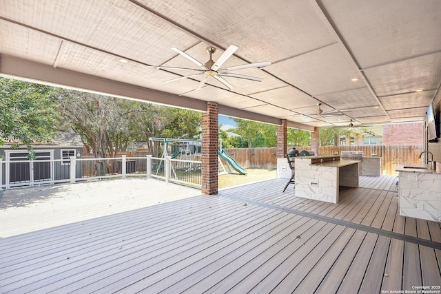 2834 Olive Ave, Schertz, TX 78154 - wooden terrace with a fenced backyard, ceiling fan, and a playground