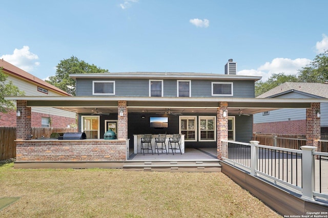 2834 Olive Ave, Schertz, TX 78154 - rear view of property featuring a ceiling fan, a chimney, exterior kitchen, and a wooden deck
