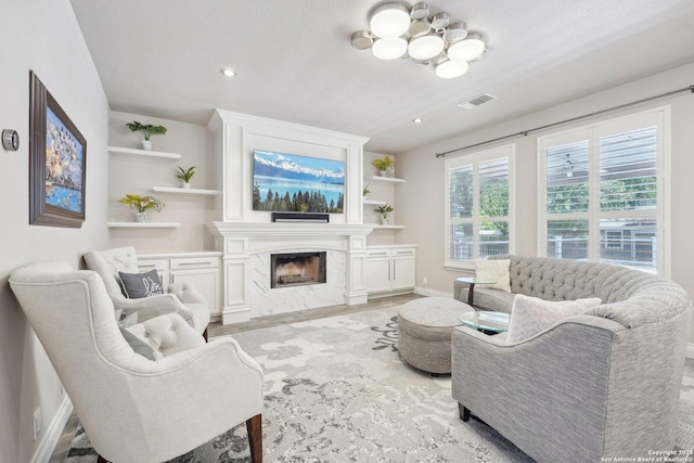 2834 Olive Ave, Schertz, TX 78154 - living room featuring baseboards, a high end fireplace, recessed lighting, and a chandelier
