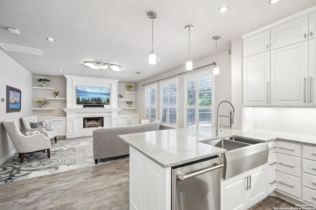2834 Olive Ave, Schertz, TX 78154 - kitchen featuring stainless steel dishwasher, a sink, wood finished floors, white cabinets, and recessed lighting